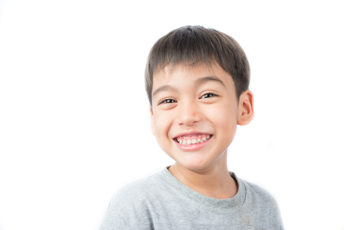Boy smiling showing healthy teeth during orthodontic treatment