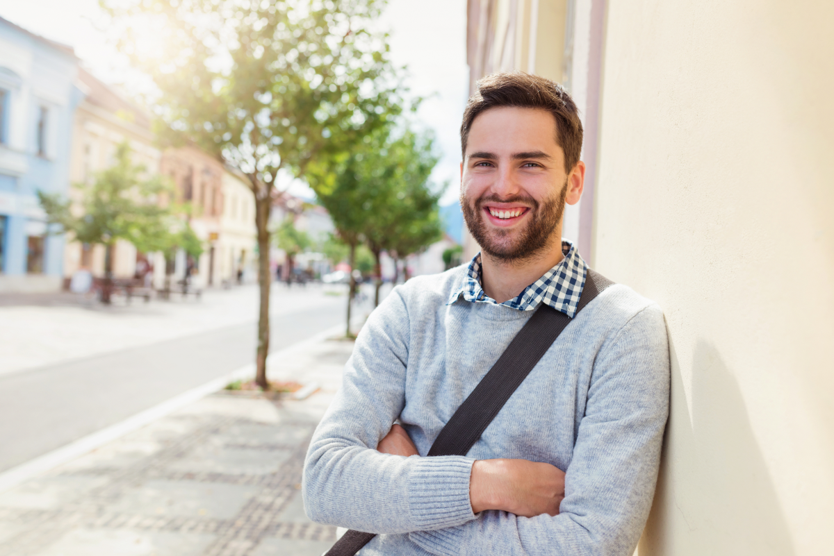 Young man smiling confidently with flexible payment options available